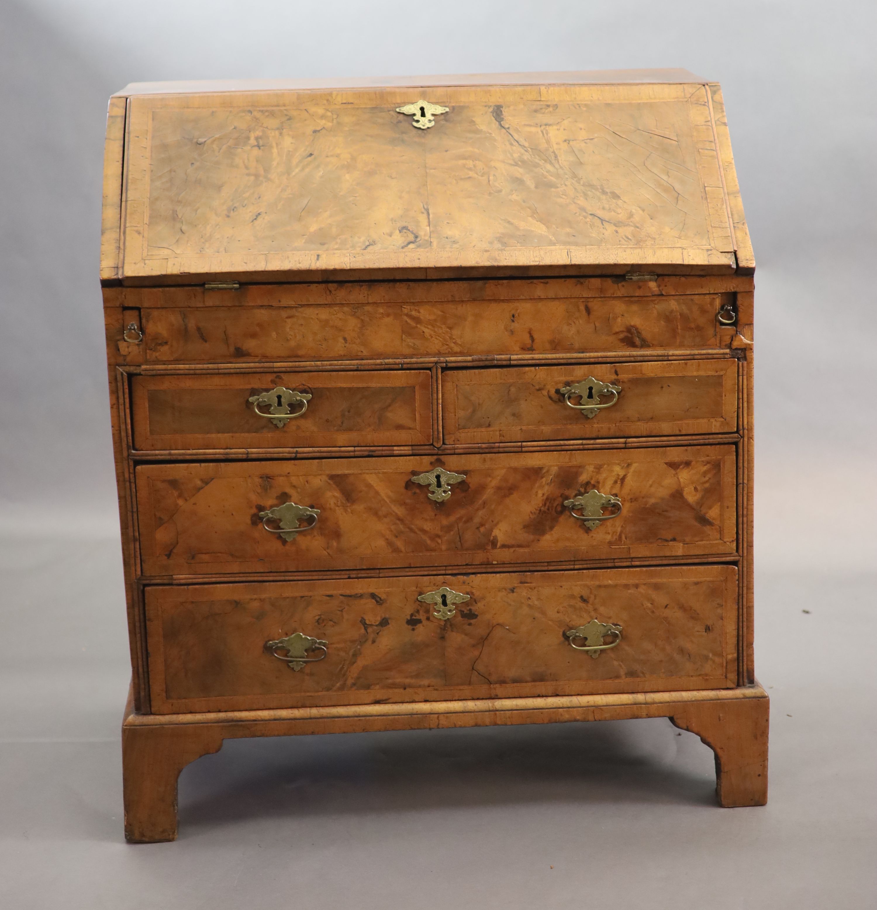 An early 18th century small walnut and crossbanded bureau, width 84cm, depth 46cm, height 98cm